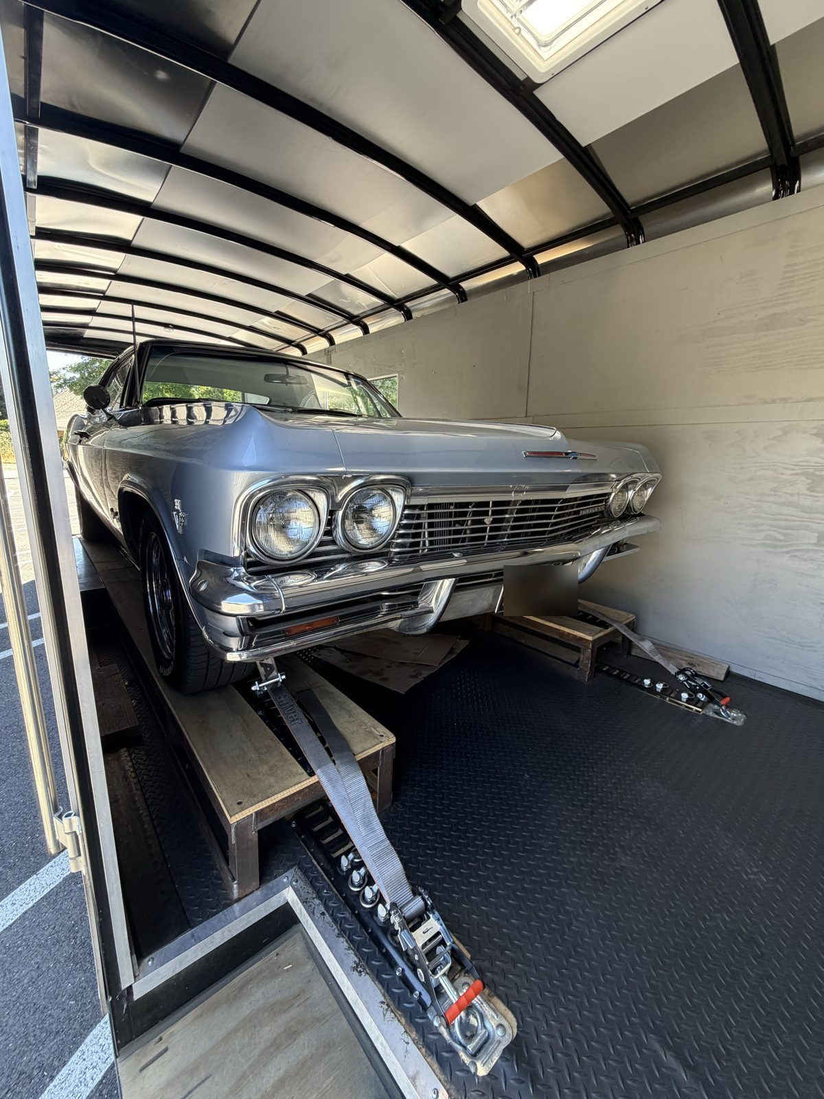 Silver 1965 Impala SS in the enclosed trailer